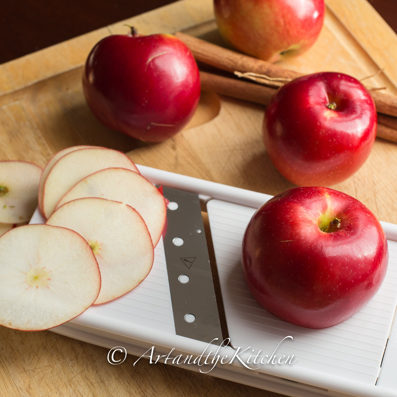 Slices of apples on mandoline slicer.