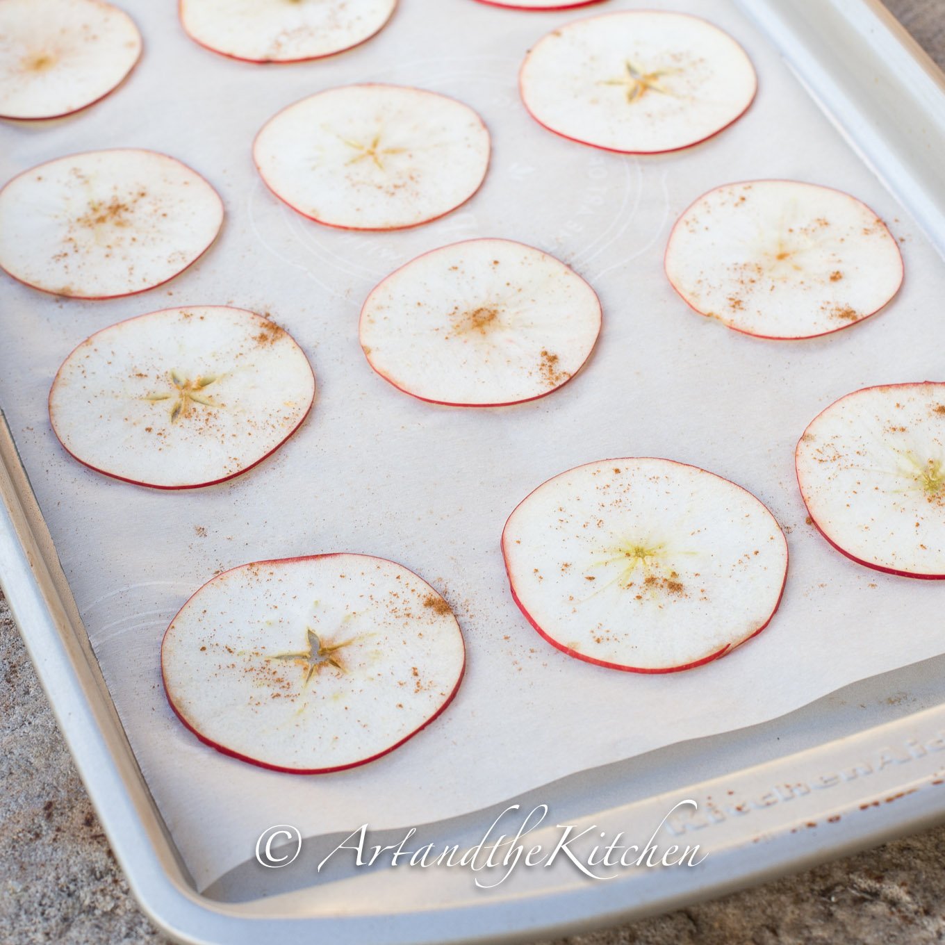 Place apple slices on parchment lined baking sheet