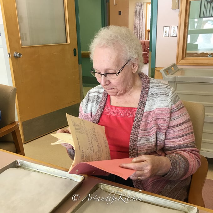Mom picking a recipe from her old cookbook