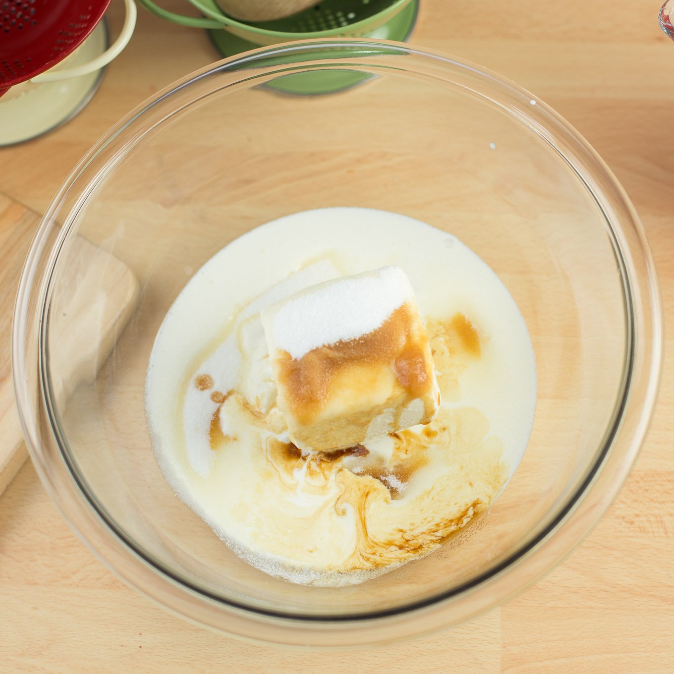 Butter, sugar and cream in glass bowl.