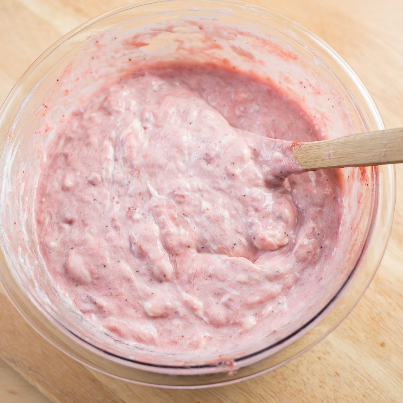 Mouse of cream cheese, strawberry in glass bowl.