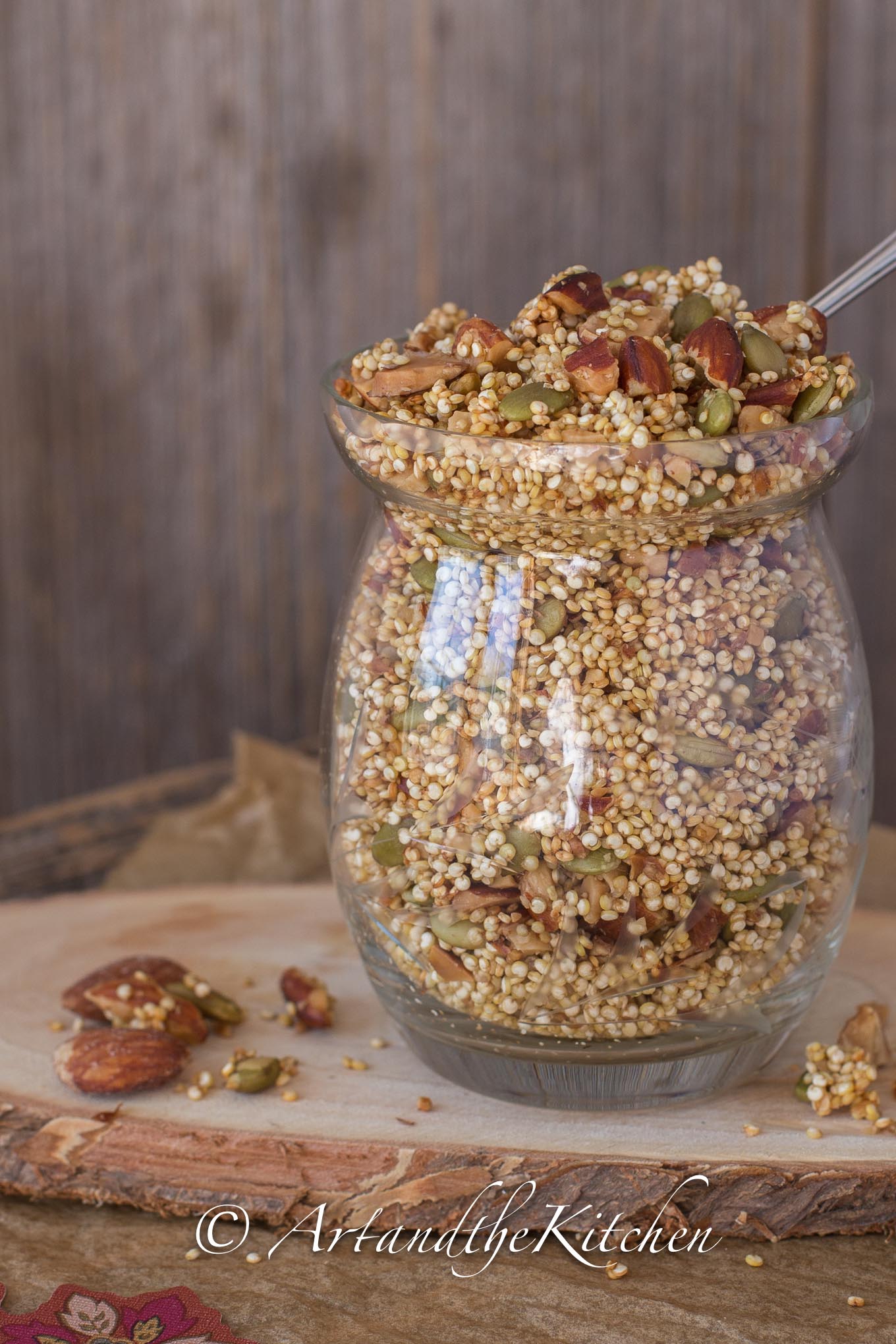 Glass jar filled with toasted quinoa, almonds, and pumpkin seed granola.