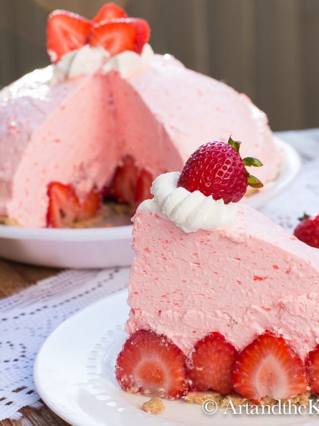 Slice of no bake strawberry pie with whole pie in background.