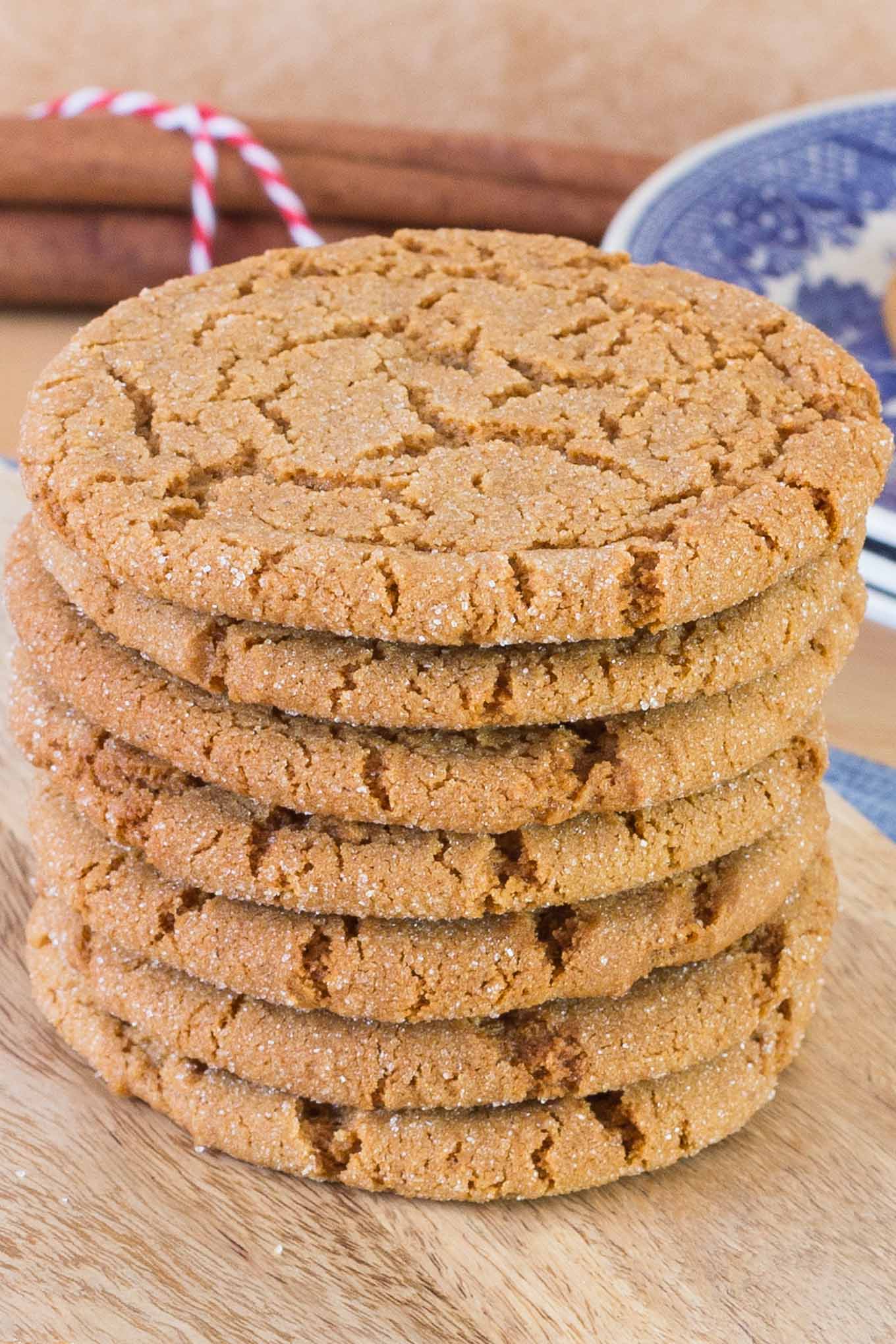 Stack of seven ginger cookies on wood board.