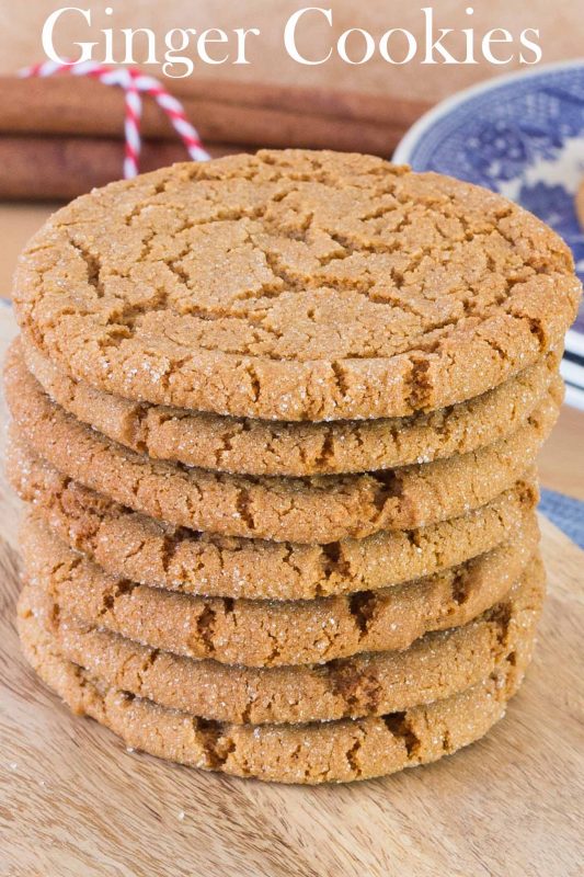 Stack of crispy ginger cookies on wood board.