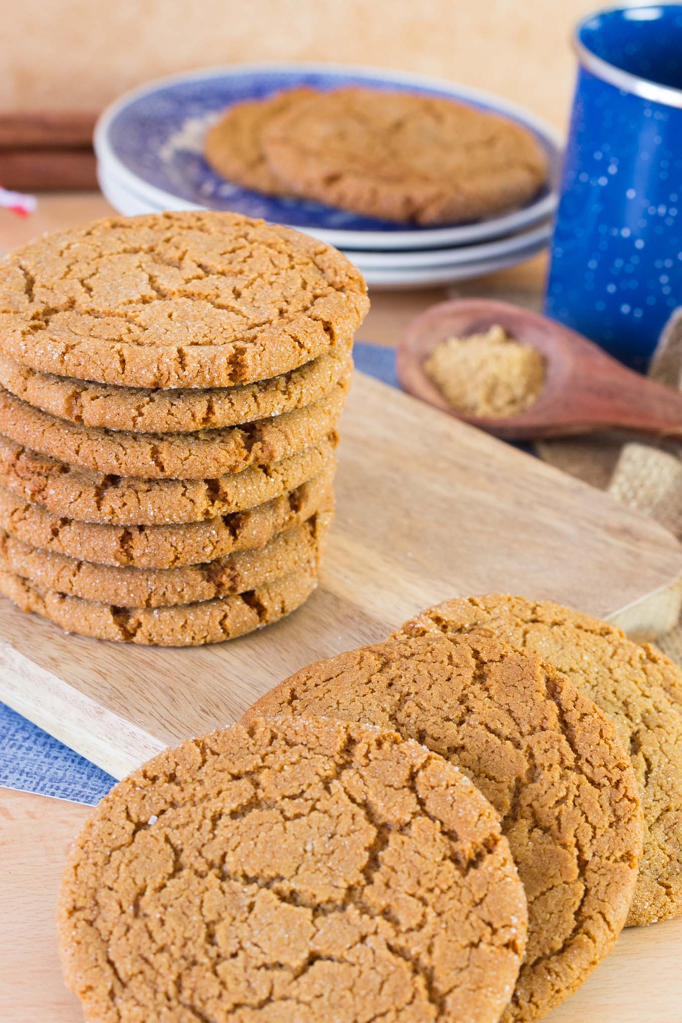 Stack of ginger cookies on wood board.