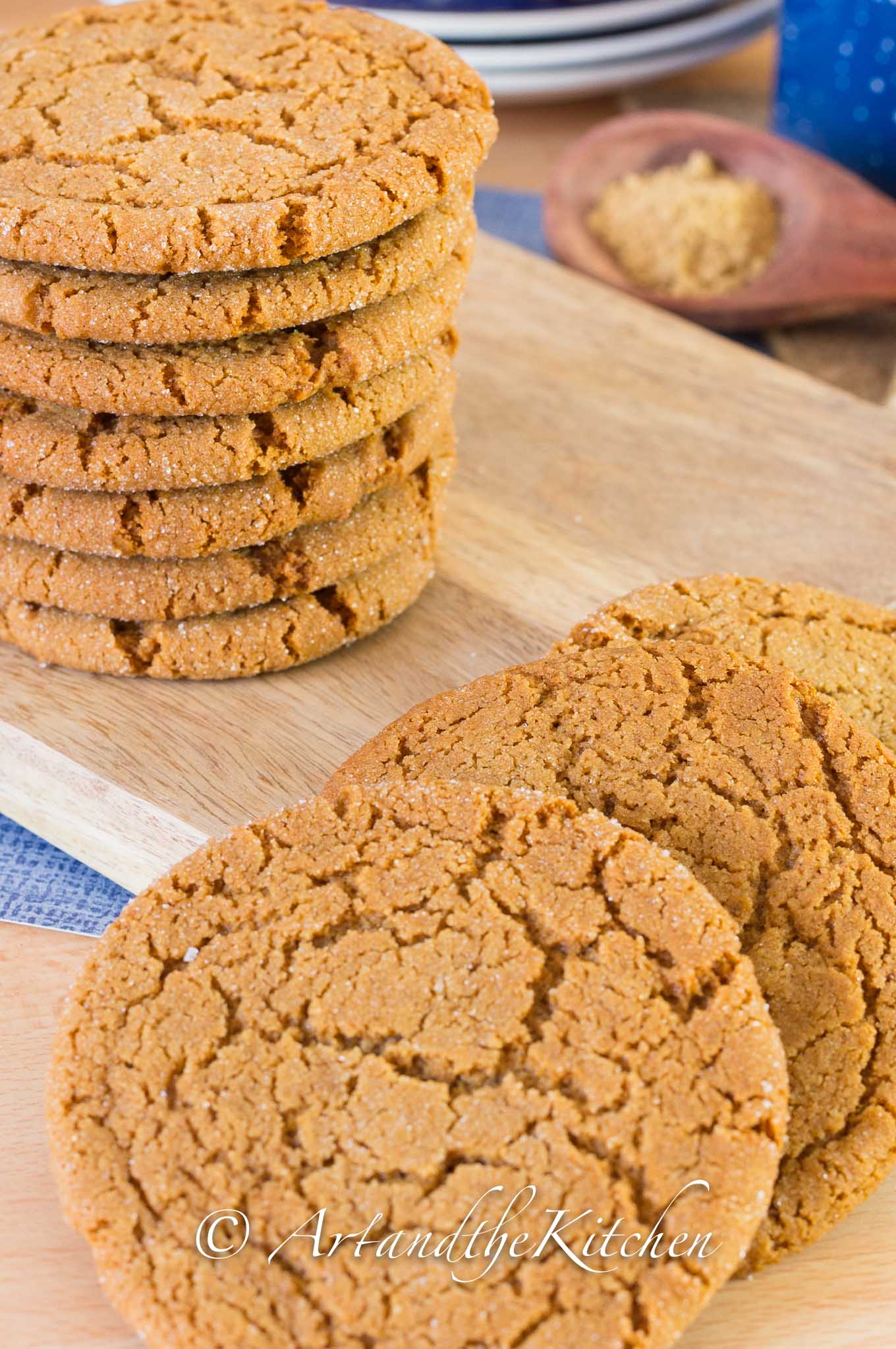 Stack of brown cookies made with ginger on wood board.