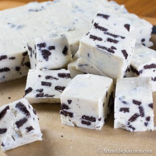 Cubes of fudge made with white chocolate and Oreo cookie pieces.