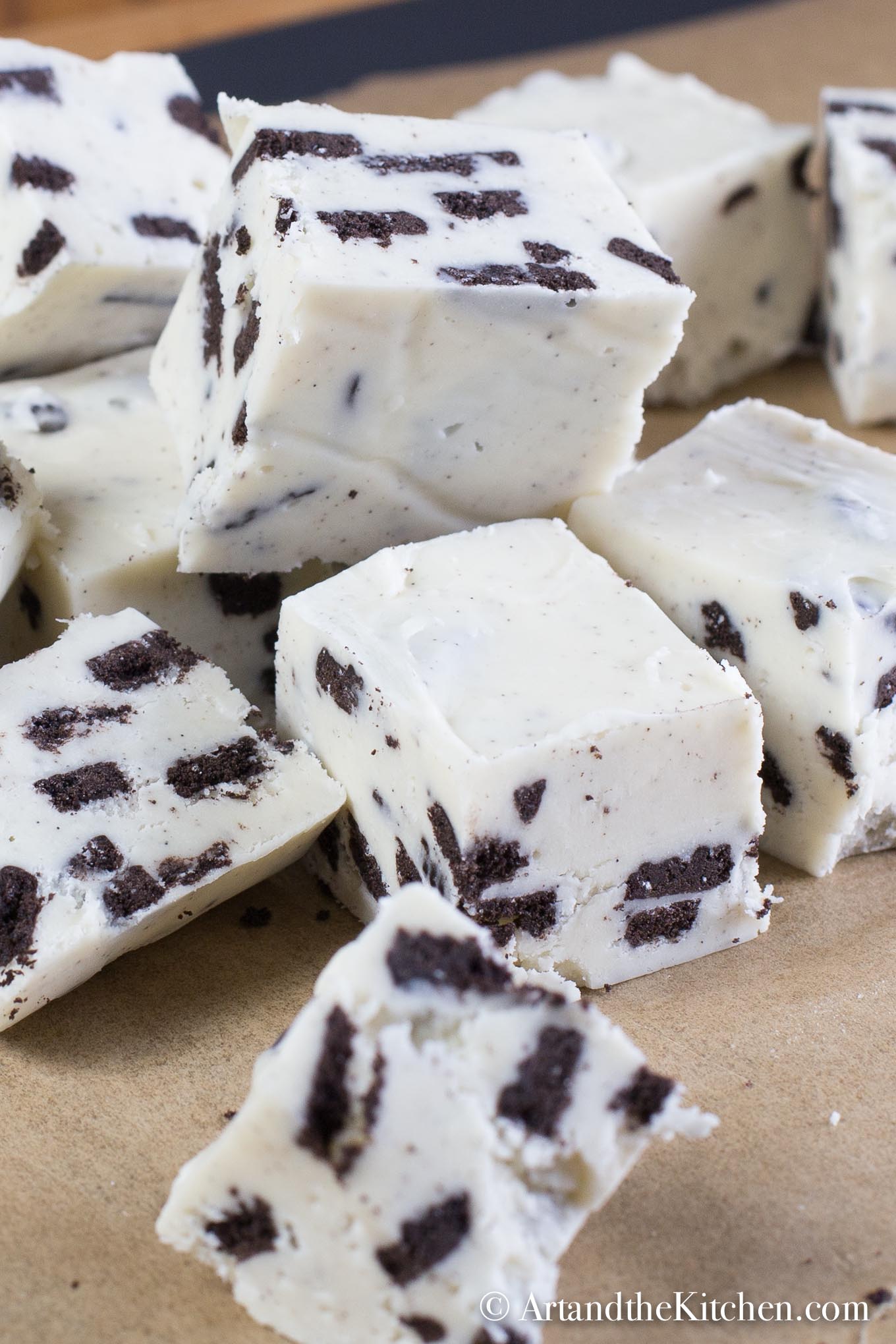 Cubes of fudge made with white chocolate and Oreo cookie pieces.