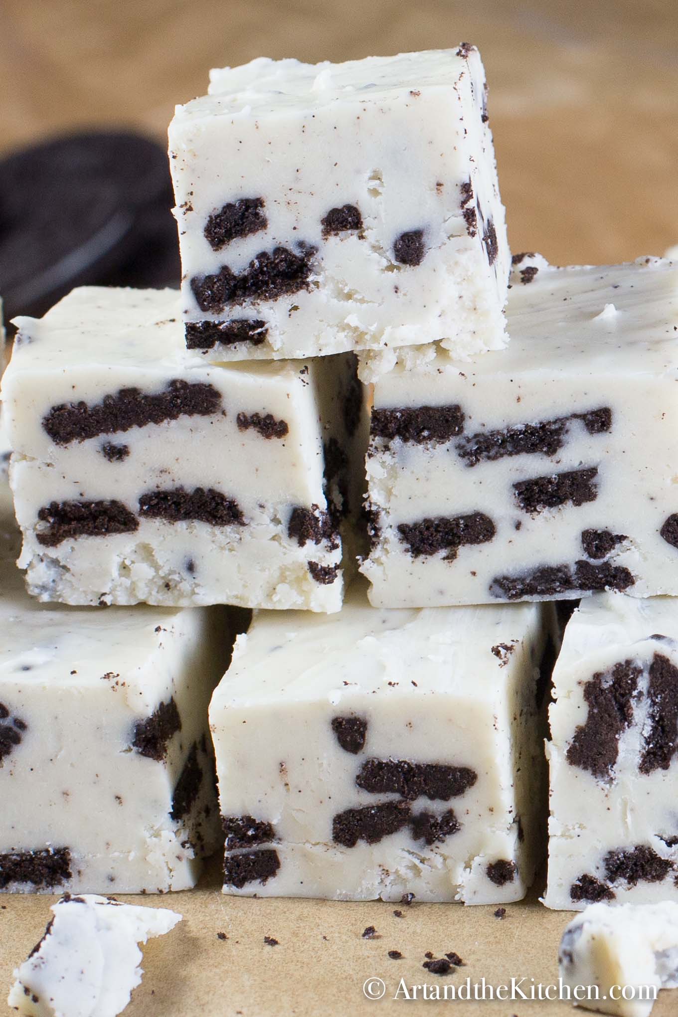 Stacked cubes of fudge made with white chocolate and Oreo cookie pieces.