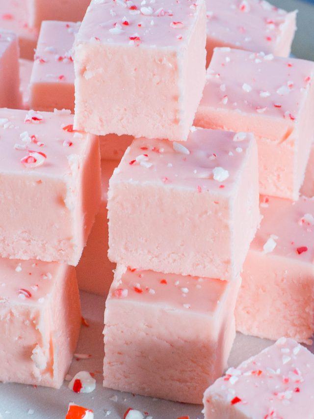 Stack of pink fudge made with ground up candy canes.