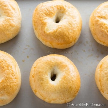 fresh baked, golden brown bagels on baking sheet. Made using a bread machine.