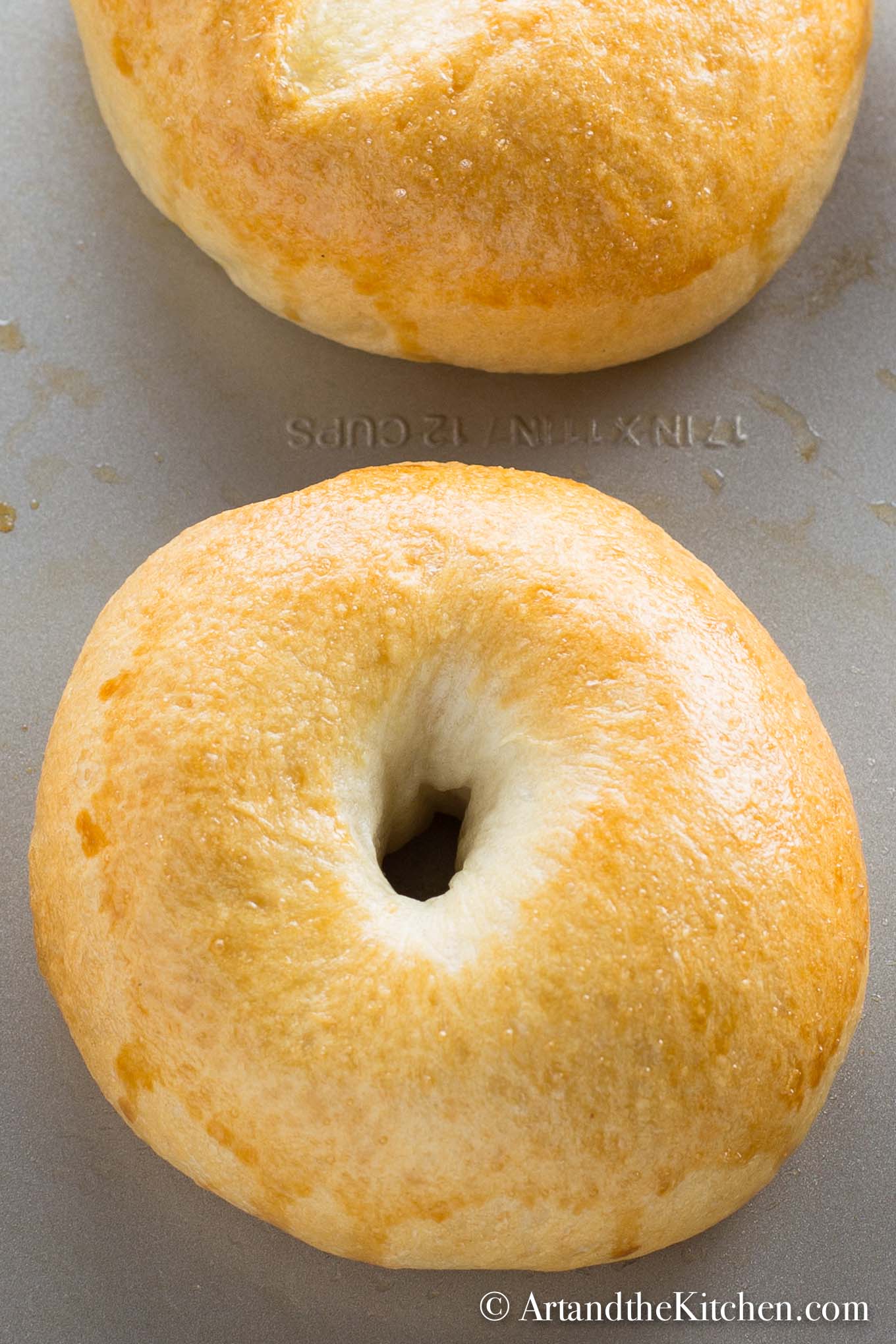 fresh baked, golden brown bagels on baking sheet. Made using a bread machine.