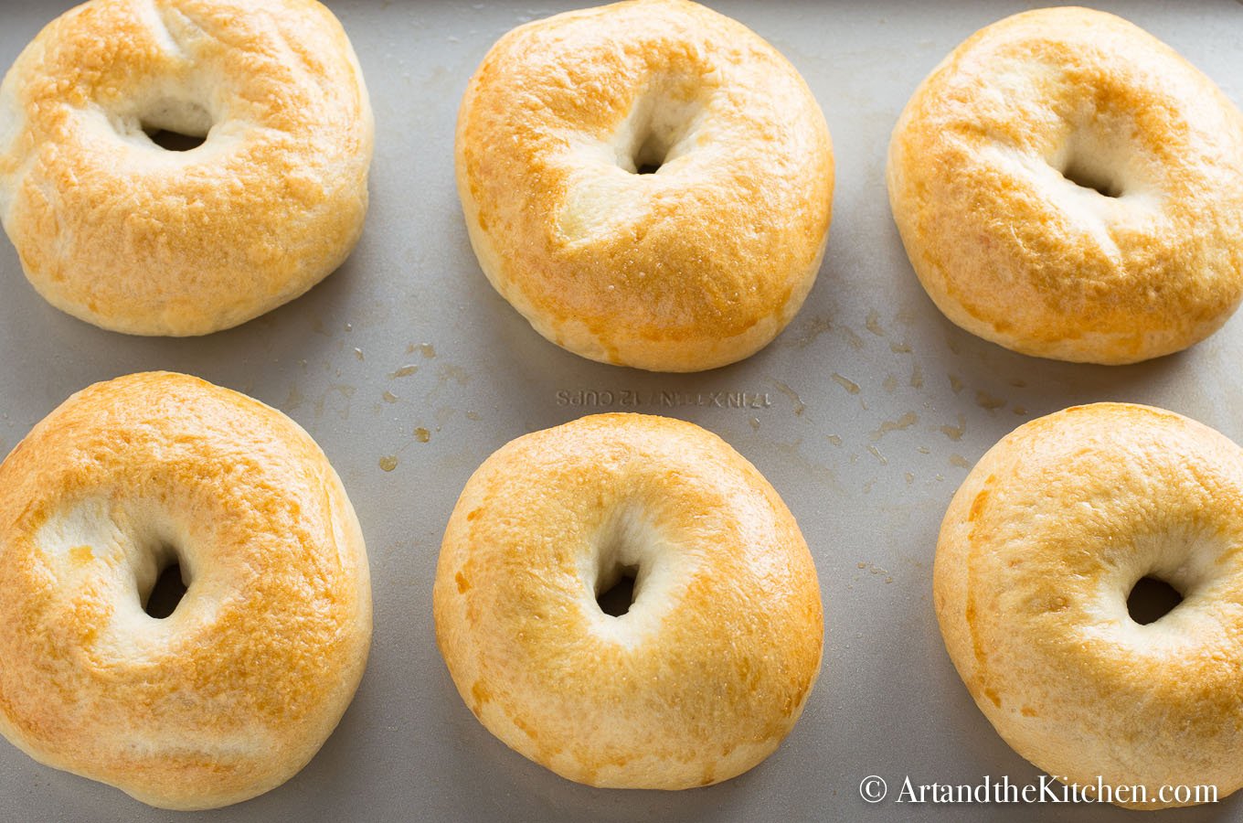 fresh baked, golden brown bagels on baking sheet. Made using a bread machine.