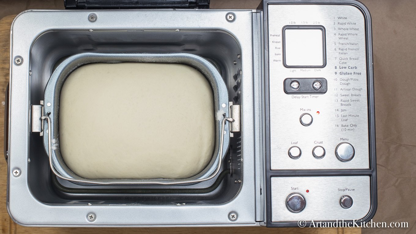 Bread machine filled with risen dough.