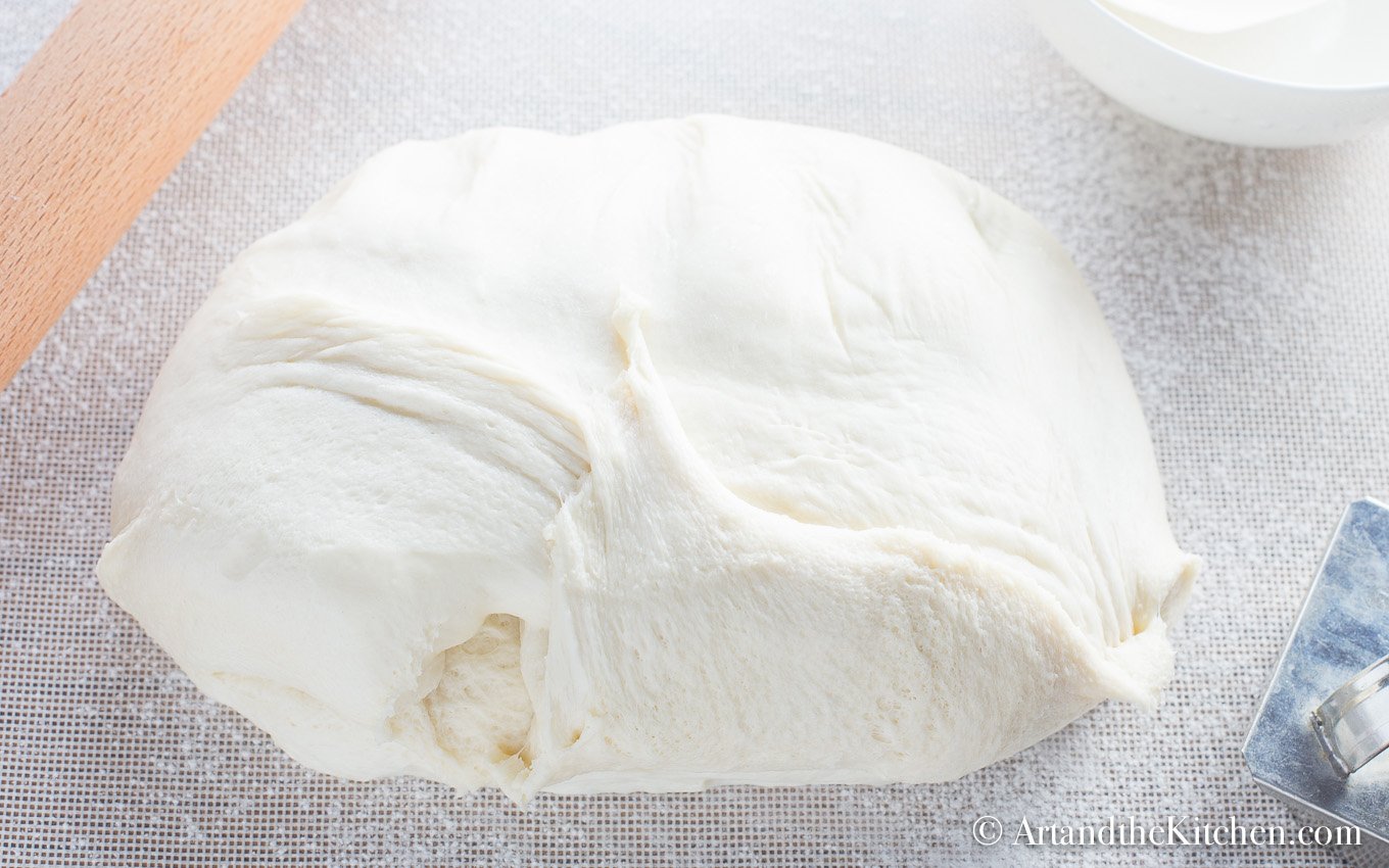 Dough for making bread machine donuts on floured surface