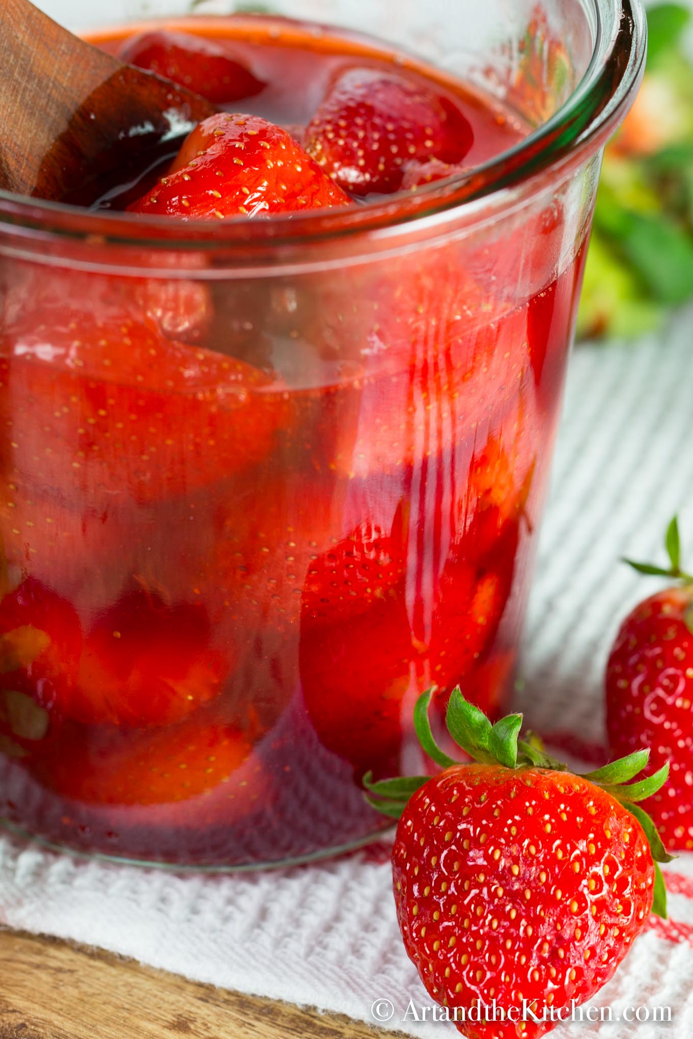 glass jar of strawberries in homemade syrup