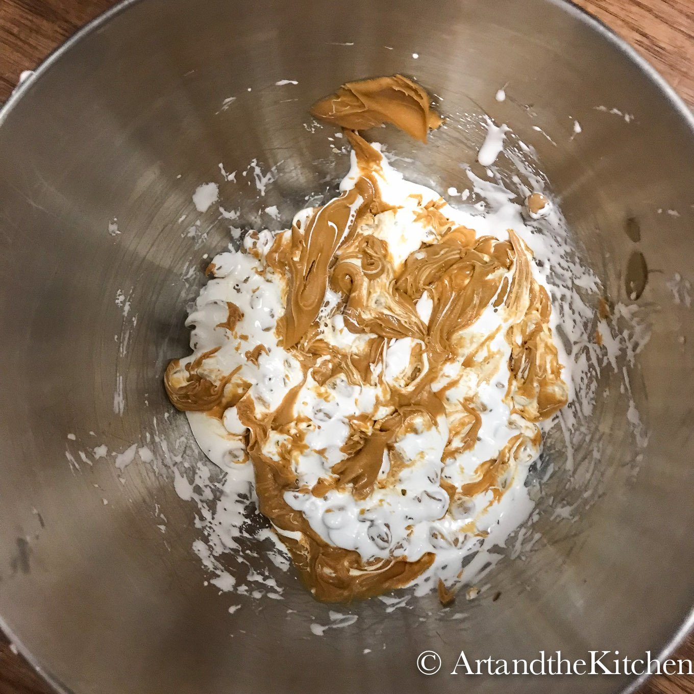 Peanut butter and marshmallow cream in stainless steel mixing bowl.