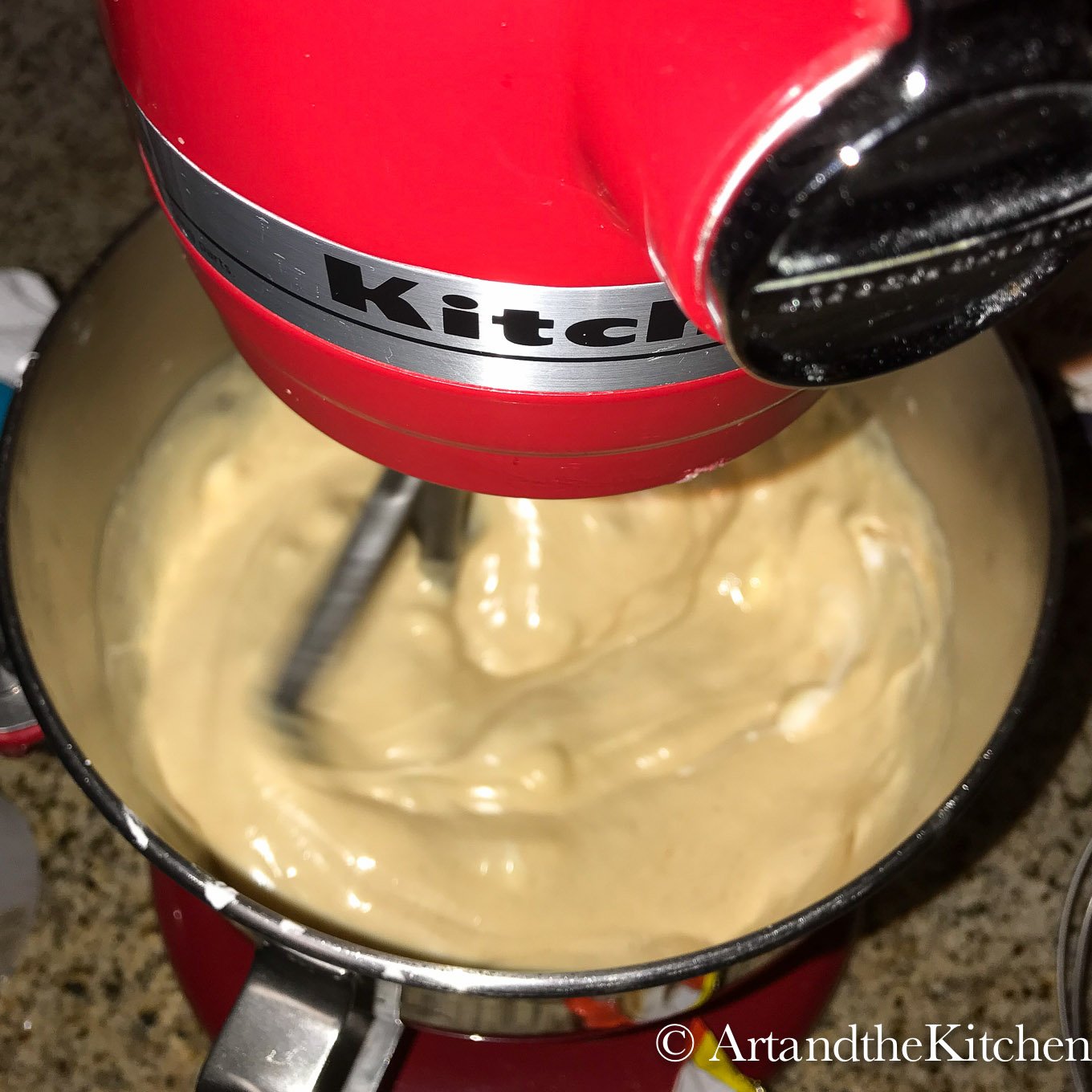 Red mixer beating peanut butter fudge.