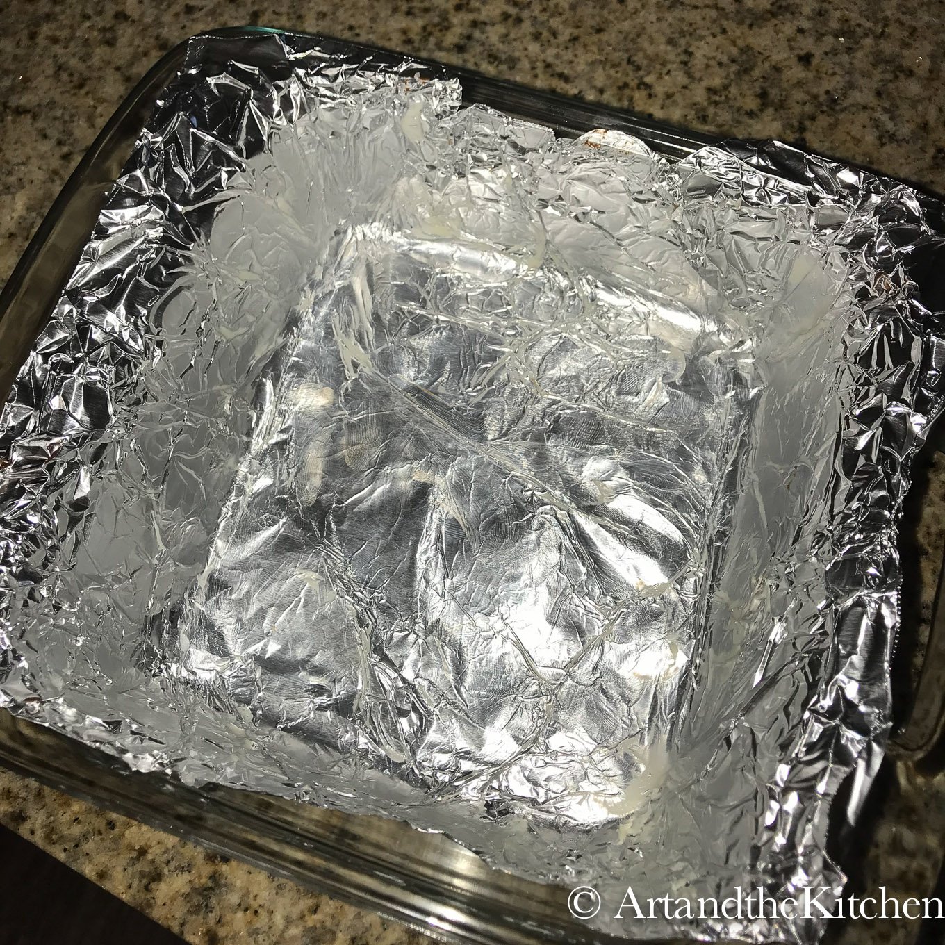 Glass baking pan lined with buttered foil wrap.