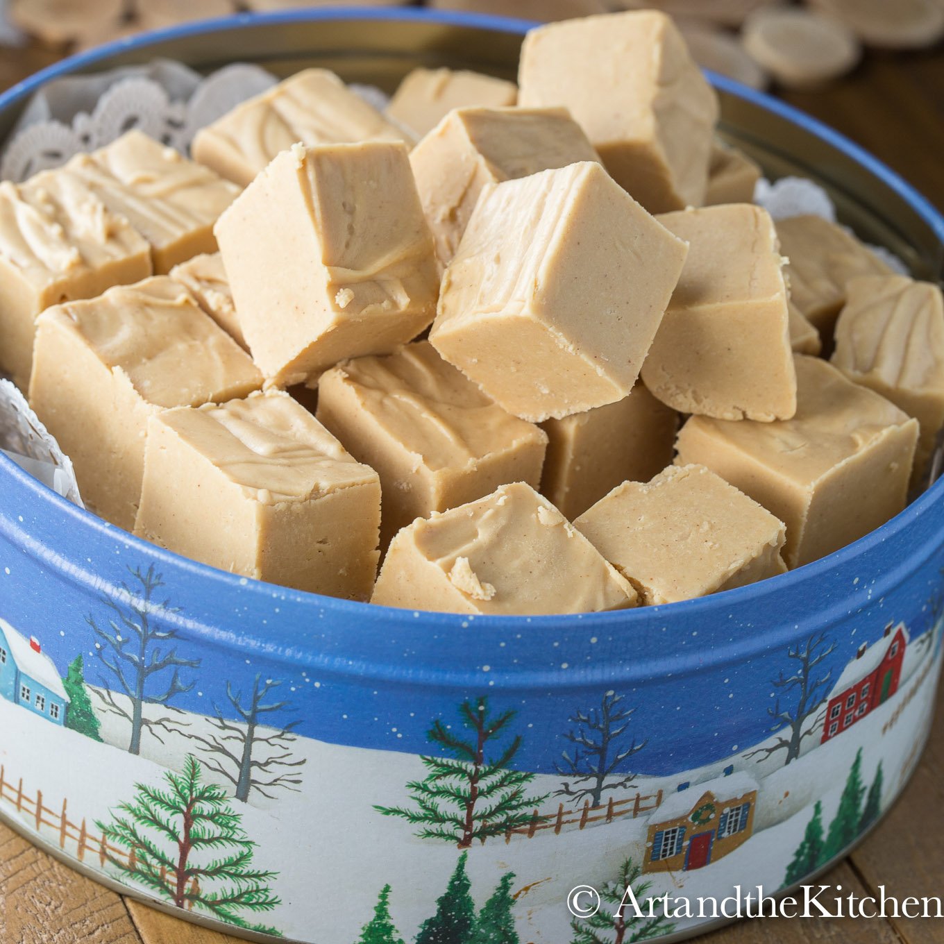 Decorative blue tin box piled with cubes of peanut butter fudge.