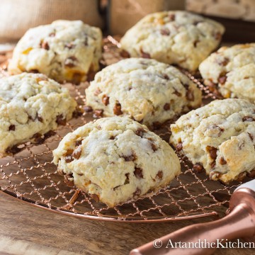 Cinnamon and raisin scones on a copper cooling rack