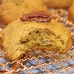 Pumpkin cookie with bite out of it on copper wire rack.