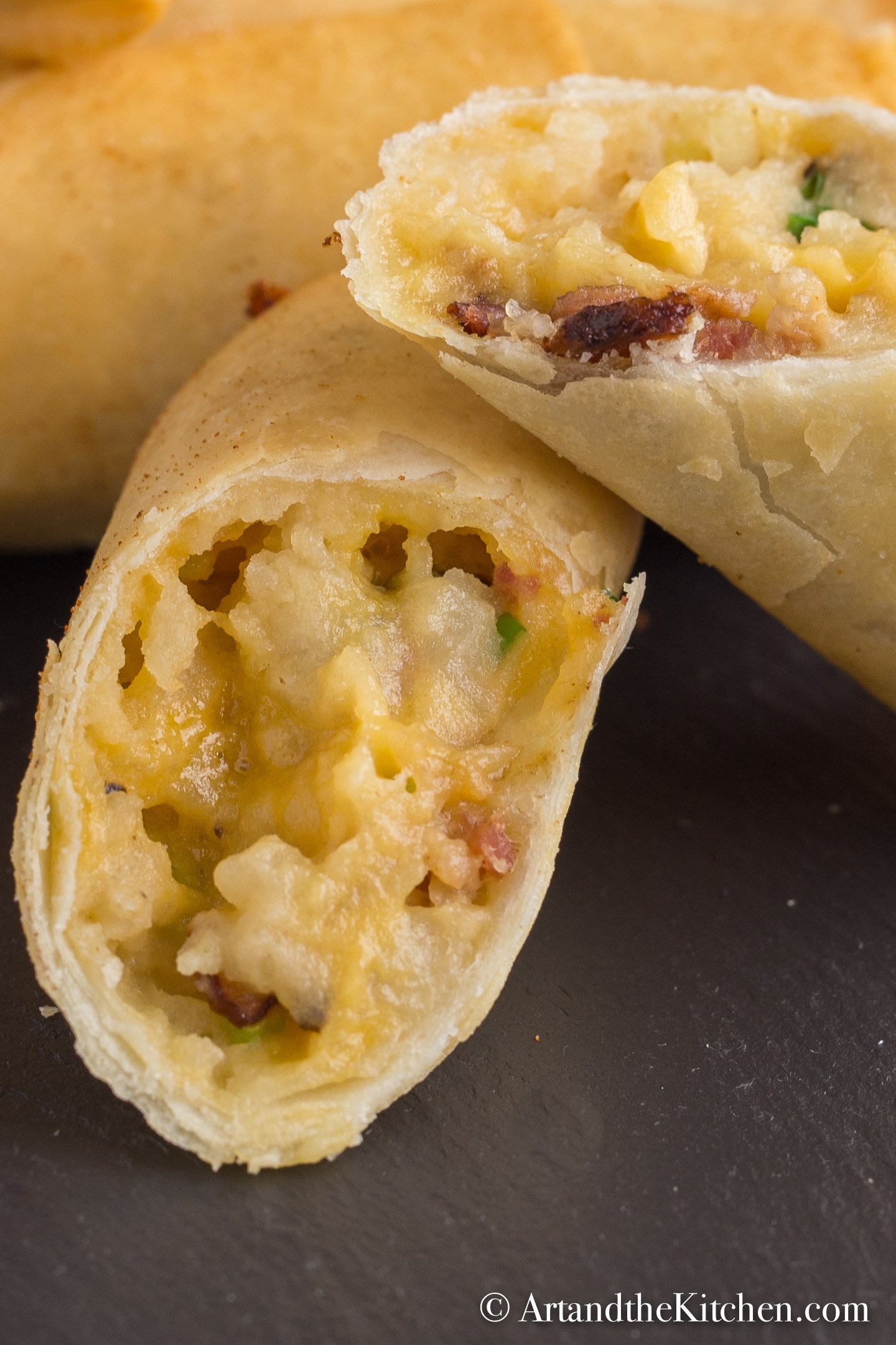 Stack of spring rolls filled with a baked potato mixture.