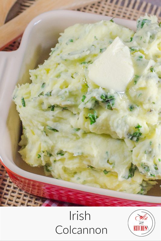 Mashed potatoes with kale topped with pat of butter.