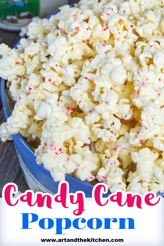Decorative Holiday container filled with popcorn coated in white chocolate and bits of candy cane.