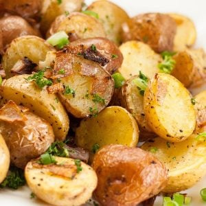 Pile of crispy roasted potatoes with onions.