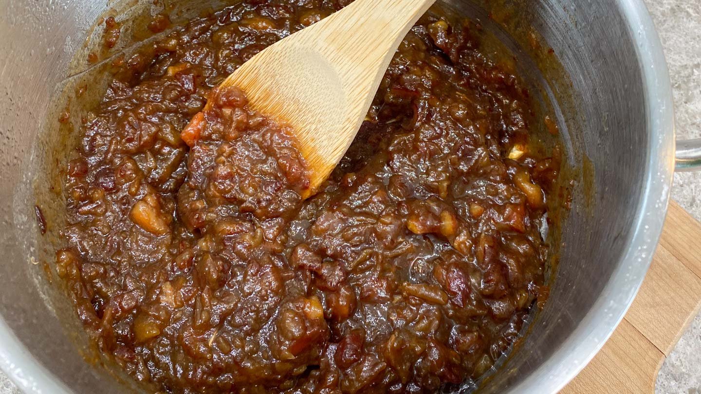 Dates cooking in stainless steel pot.