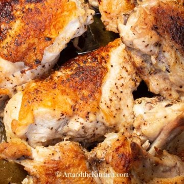 Golden brown roasted chicken pieces in dutch oven