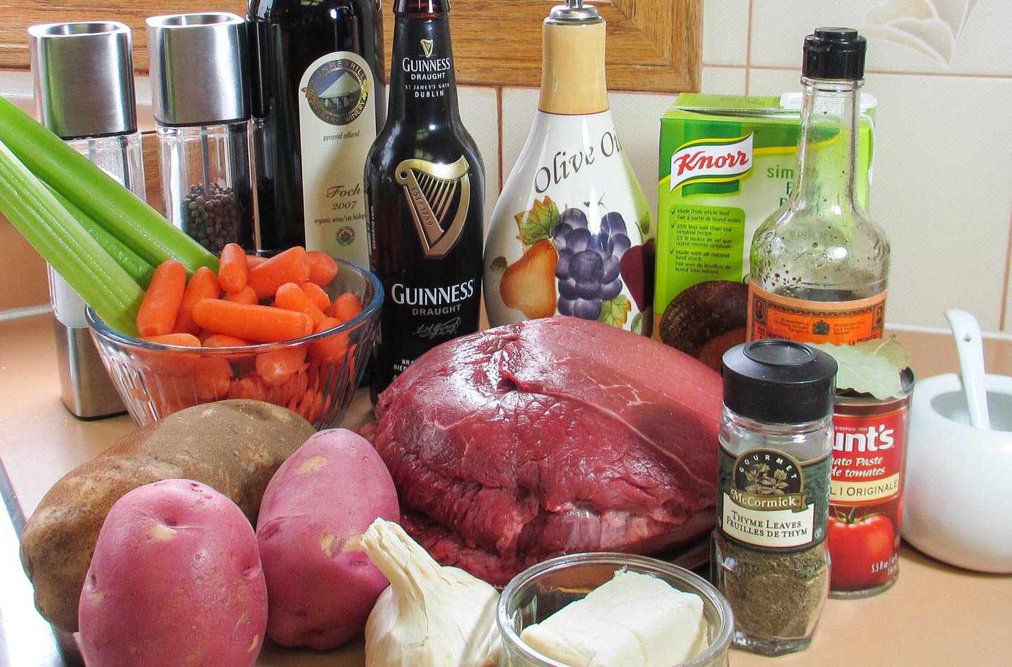 Chuck of beef, vegetables and all ingredients for making Irish Stew.