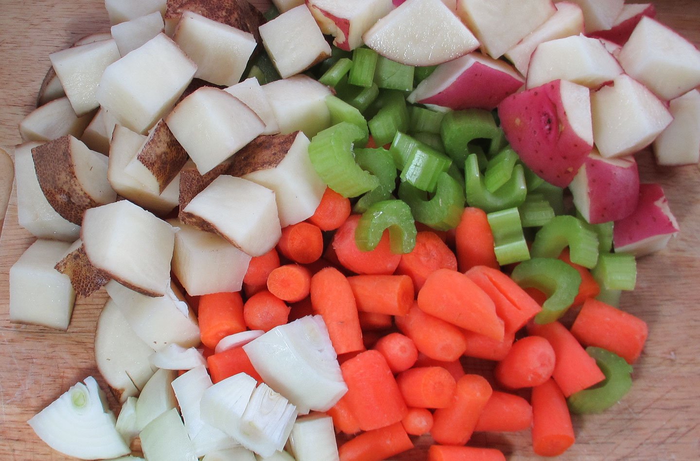 Cubes of potatoes, celery, carrots, and onions.