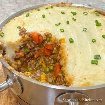 Stainless steel baking dish filled with baked shepherd's pie.
