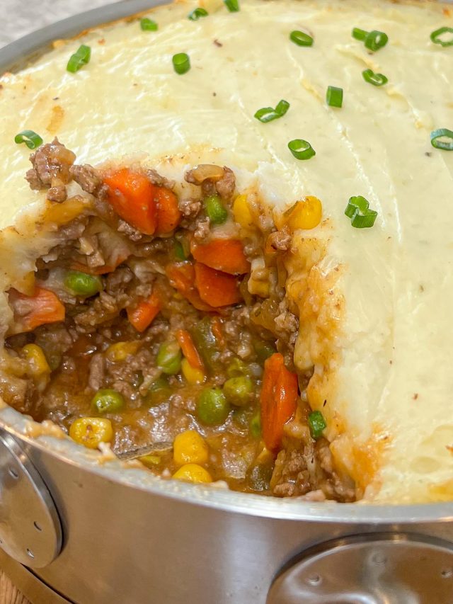 Stainless steel baking dish filled with baked shepherd's pie.