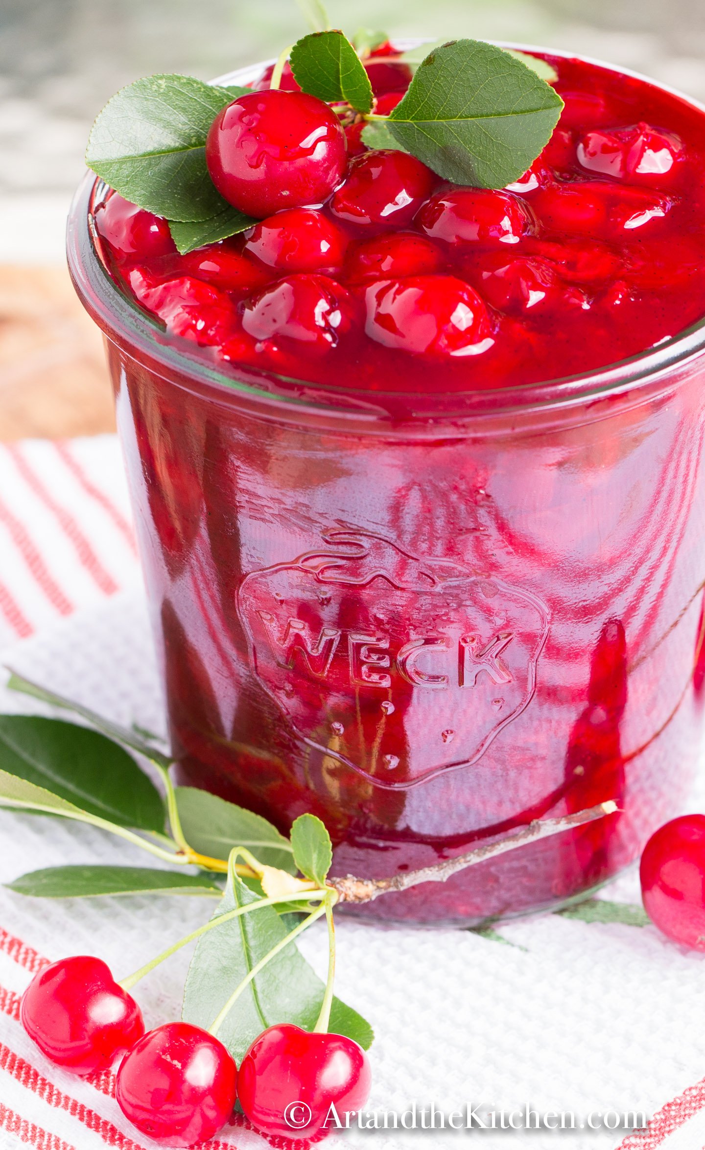 Glass jar filled with cherry sauce.