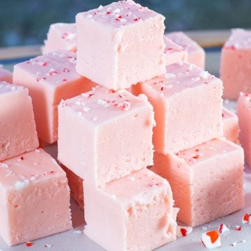 Stack of cubes of pink candy cane fudge.