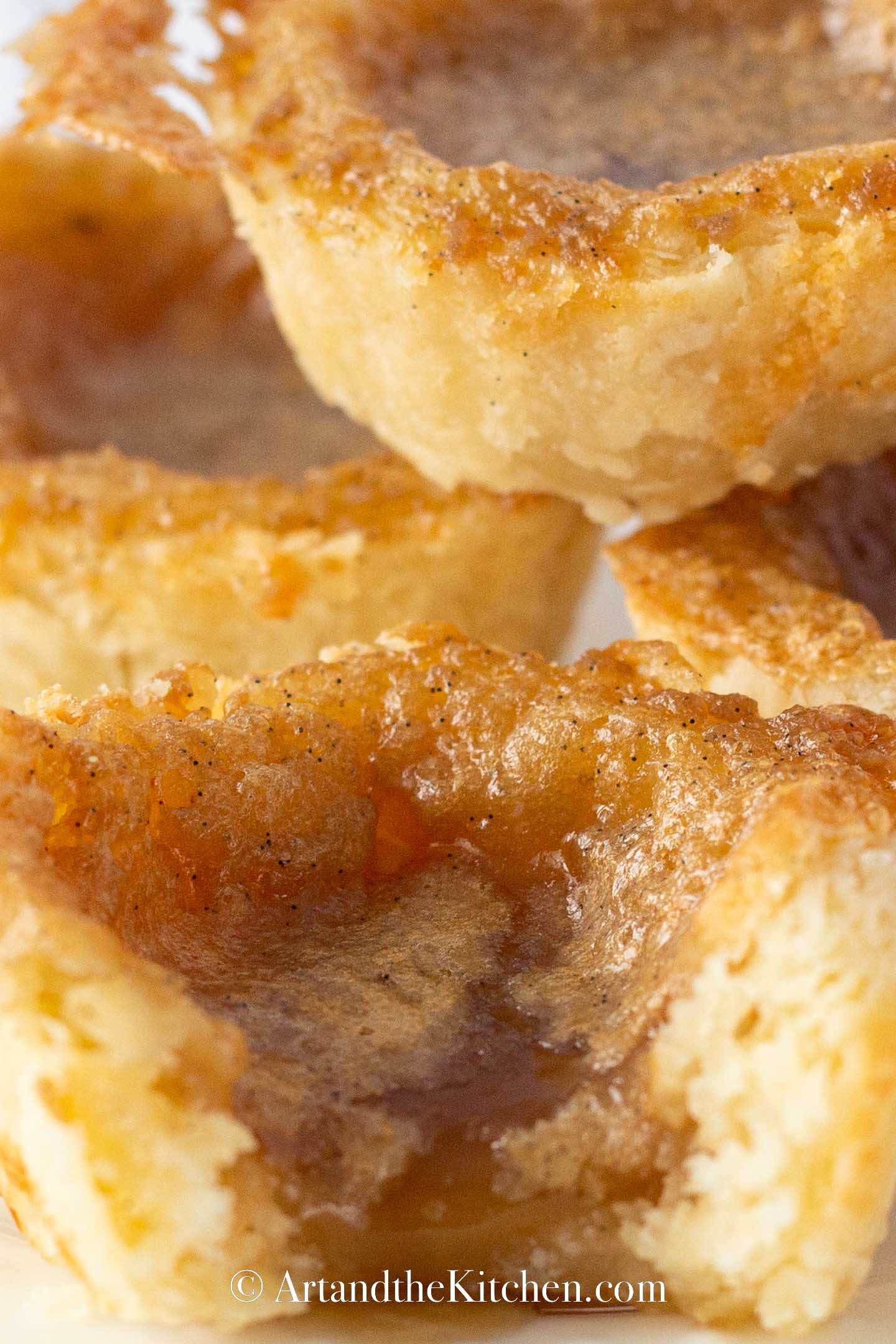 Stack of butter tarts with bite out of one of them.