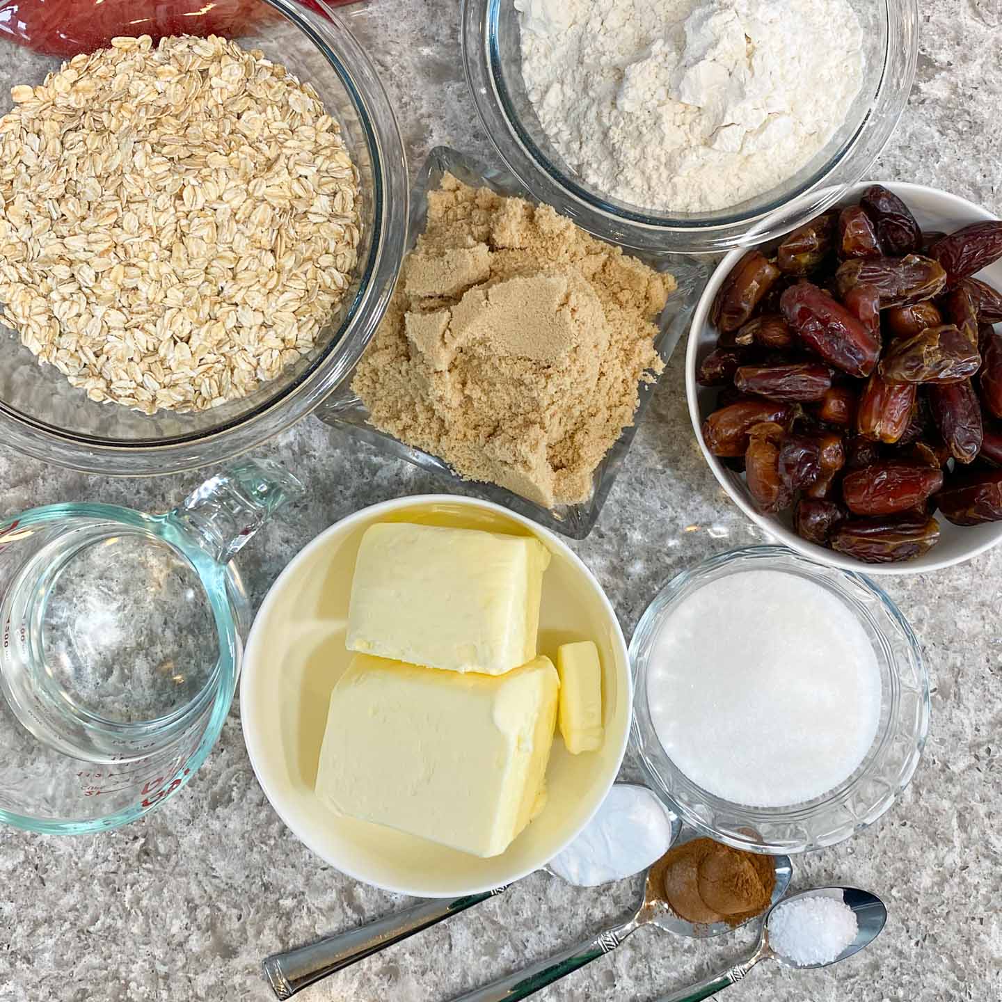 Ingredients measured in bowls for making date squares.