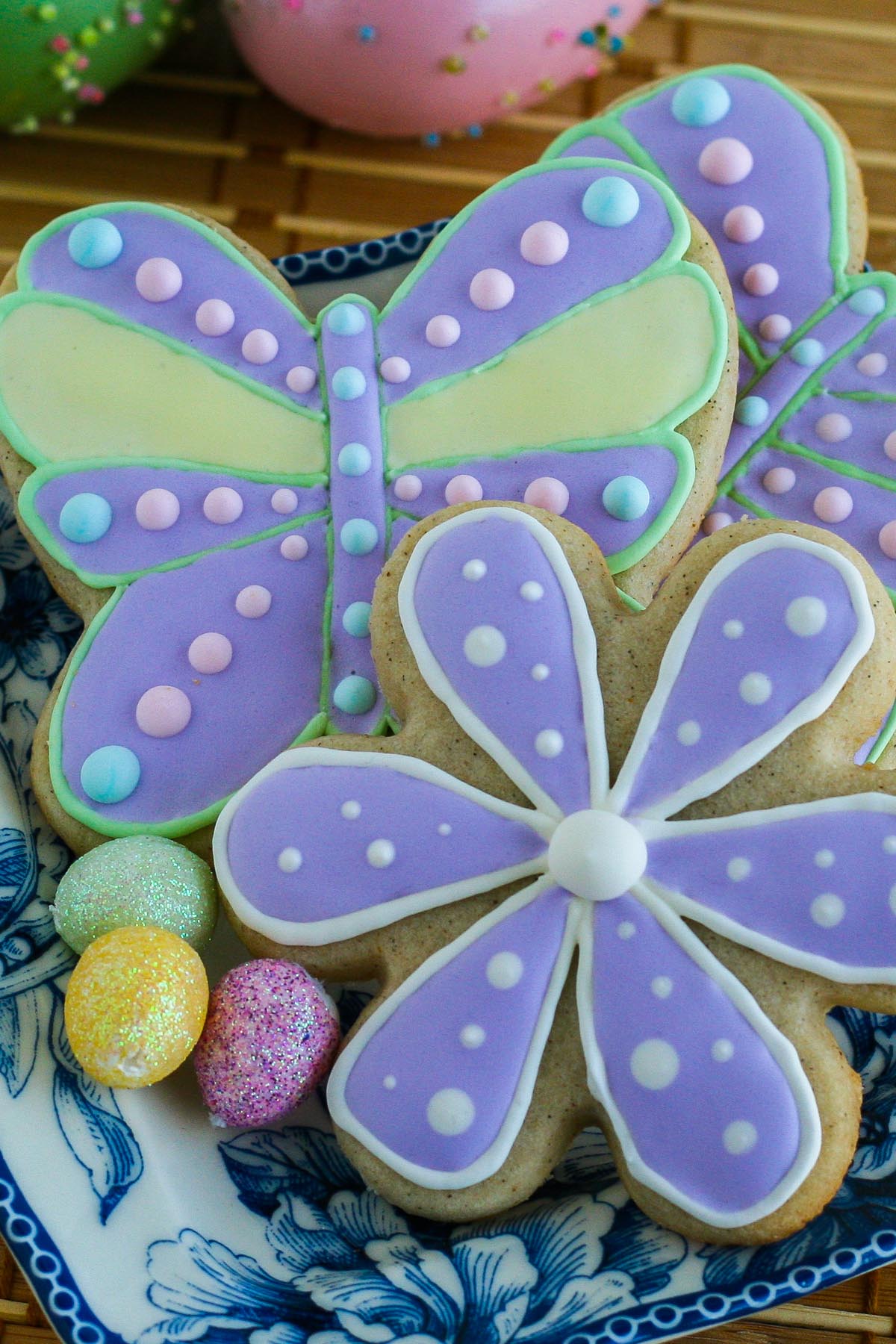 Flower and butterfly shaped sugar cookies decorated with colourful royal icing.