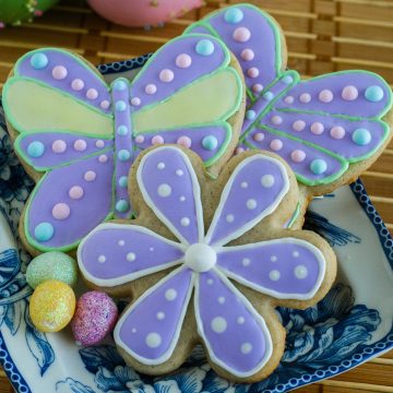 Flower and butterfly shaped sugar cookies decorated with colourful royal icing.