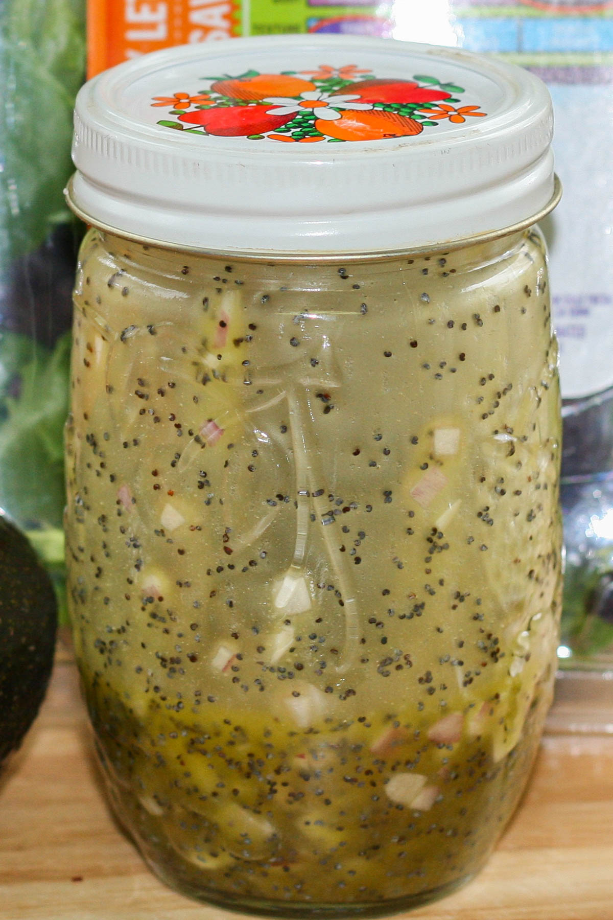 A small glass jar filled with homemade poppyseed dressing.