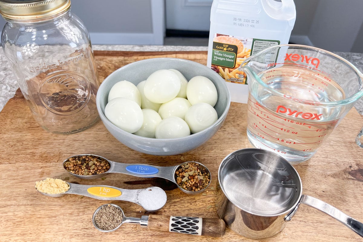 Ingredients for making pickled eggs in measuring spoons and bowls.