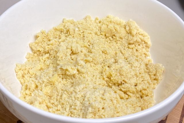 Crumbled lemon cake mix in white bowl.