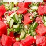Clay bowl of watermelon, cucumber, mint, and feta cheese salad.