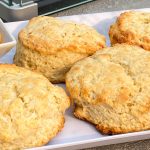 Freshly baked scones on white serving tray.