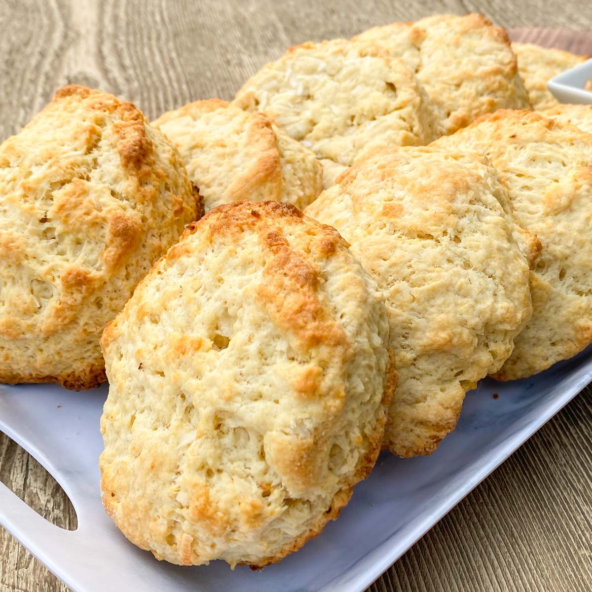 Freshly baked scones on white serving tray.