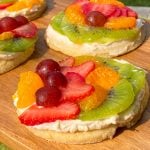 Sugar cookies topped with cream cheese and fresh fruit.